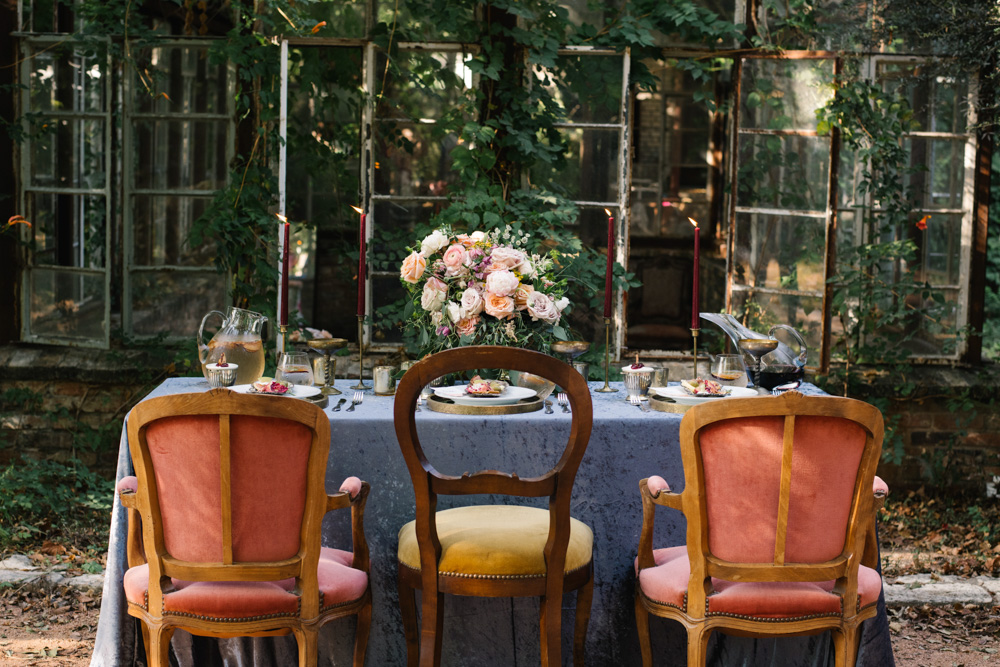 Photo of a wedding scape table with floral arrangements and little snacks.