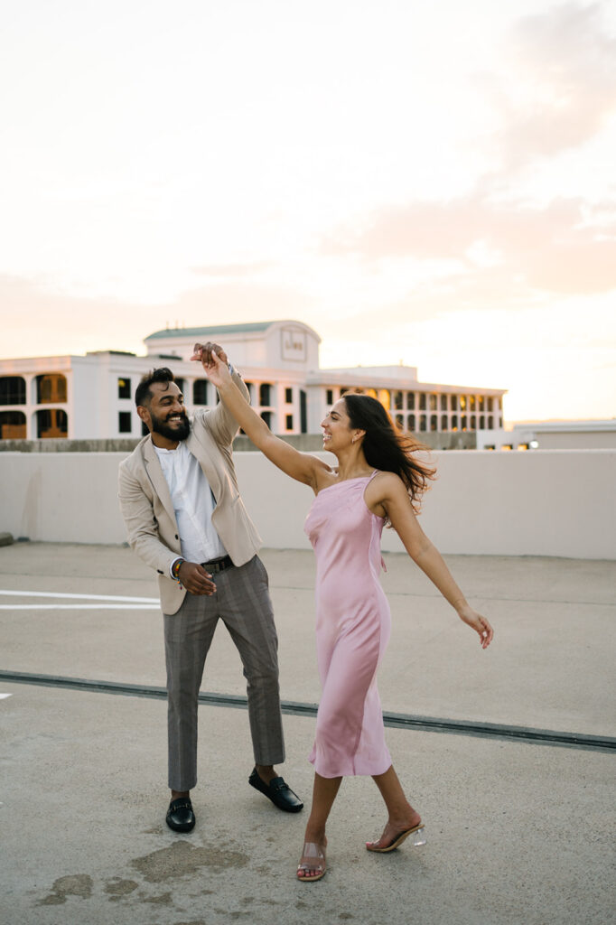 Candid, fun, documentary engagement photo on a rooftop downtown, top six engagement session location in austin texas.