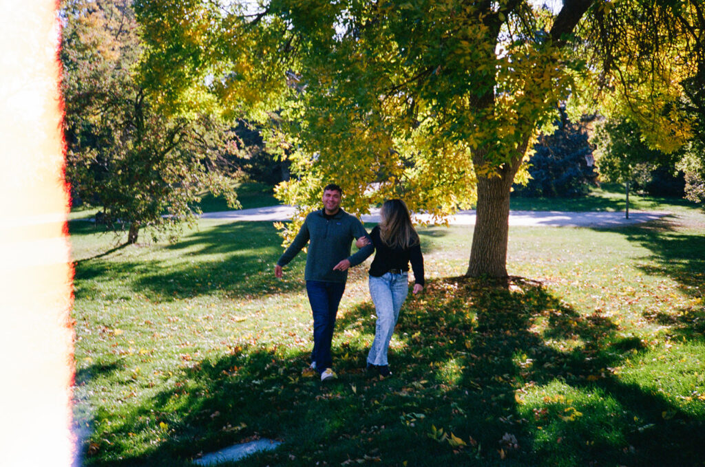 35mm film engagement session in Denver Colorado - couple laughing during golden hour
