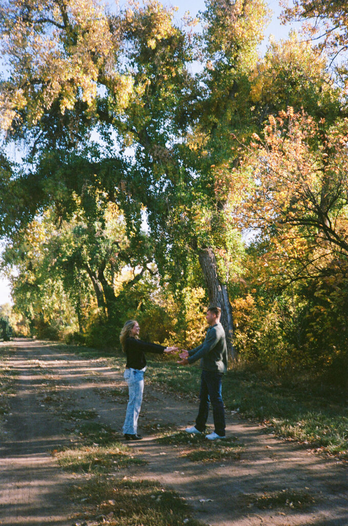 35mm film engagement session in Denver Colorado - couple laughing during golden hour
