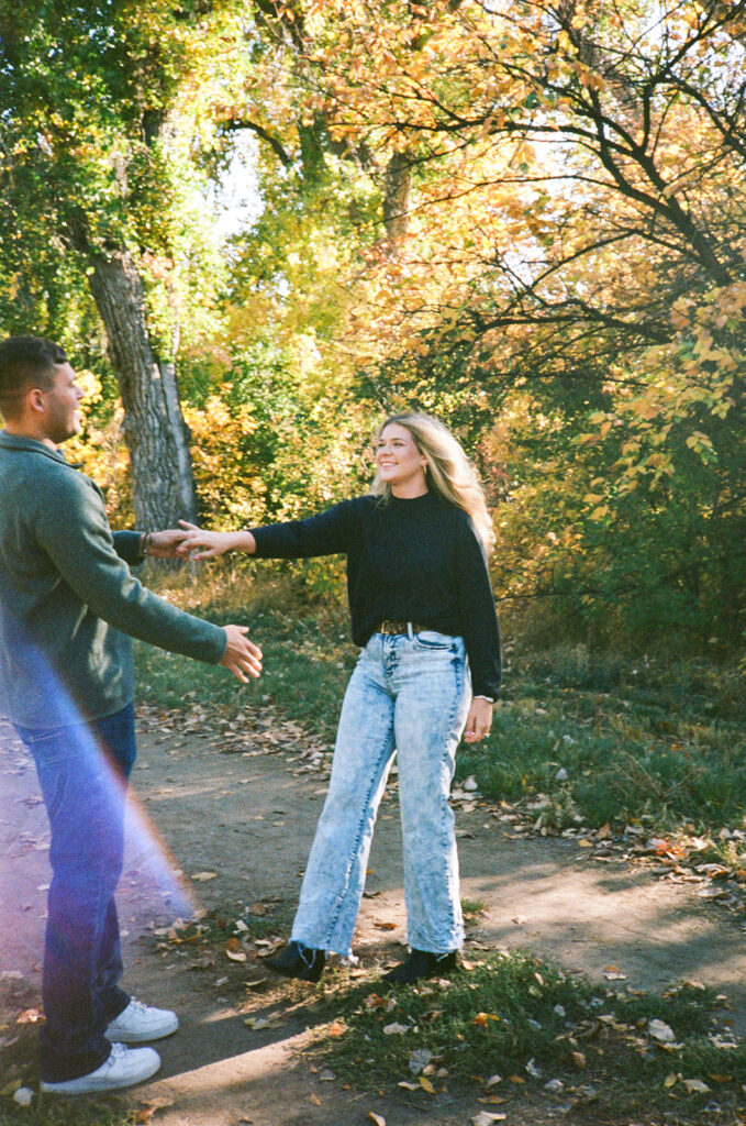 35mm film engagement session in Denver Colorado - couple laughing during golden hour