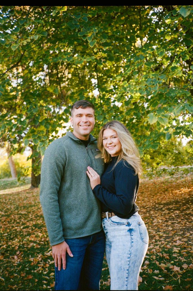 35mm film engagement session in Denver Colorado - couple laughing during golden hour
