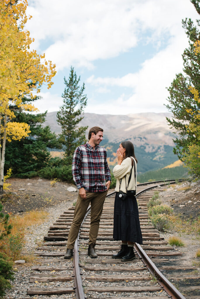 Couple celebrating their surprise engagement at Boreas Pass with  mountain views in Breckenridge, Colorado.