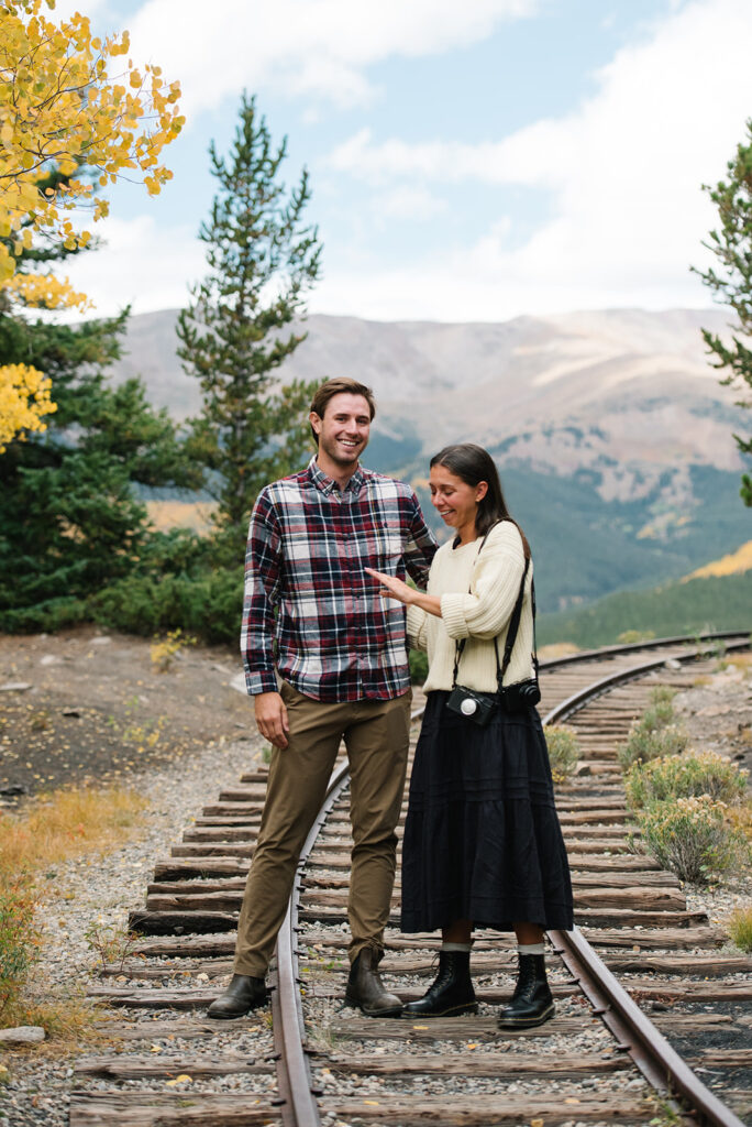 Couple celebrating their surprise engagement at Boreas Pass with  mountain views in Breckenridge, Colorado.