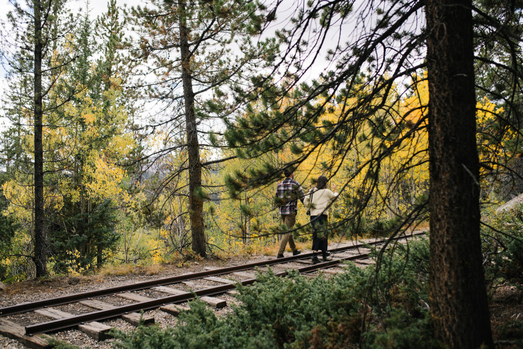 Couple celebrating their surprise engagement at Boreas Pass with  mountain views in Breckenridge, Colorado.