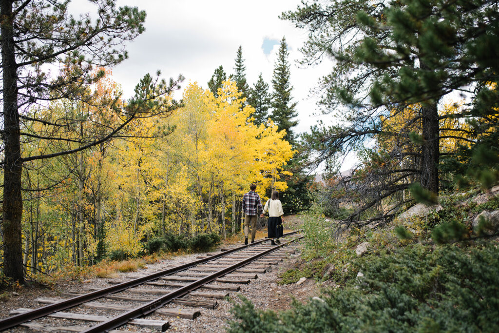 Couple celebrating their surprise engagement at Boreas Pass with  mountain views in Breckenridge, Colorado.