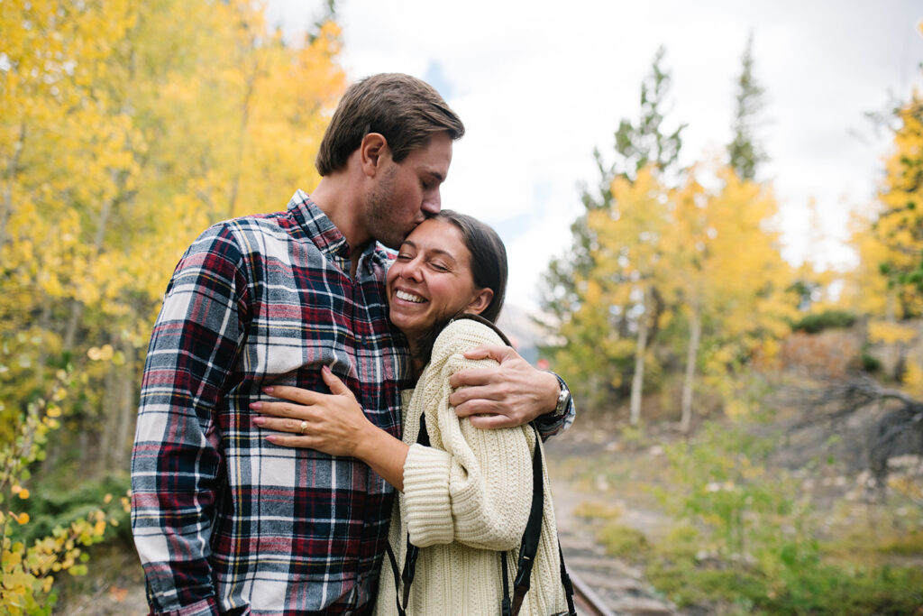 Couple celebrating their surprise engagement at Boreas Pass with  mountain views in Breckenridge, Colorado.