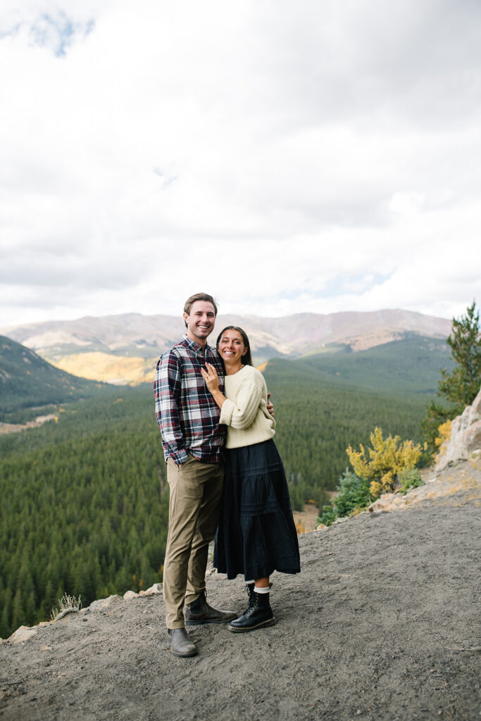 Couple celebrating their surprise engagement at Boreas Pass with  mountain views in Breckenridge, Colorado.