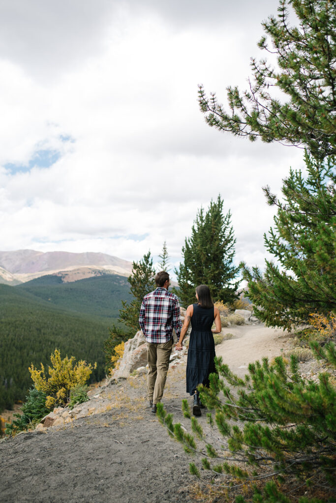 Couple celebrating their surprise engagement at Boreas Pass with  mountain views in Breckenridge, Colorado.