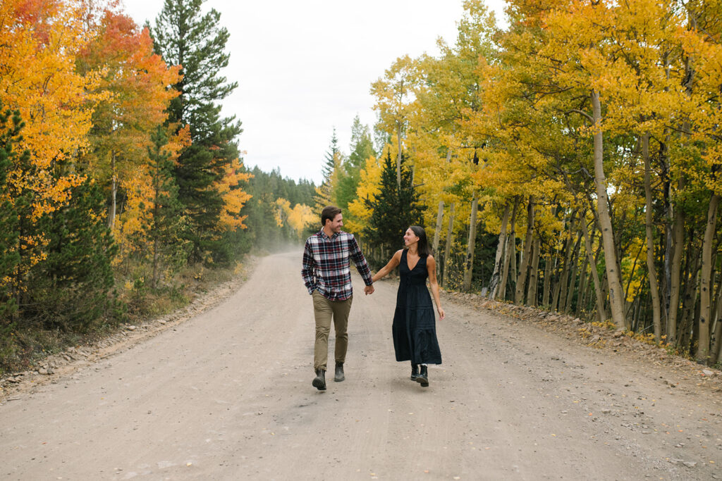 Couple celebrating their surprise engagement at Boreas Pass with  mountain views in Breckenridge, Colorado.