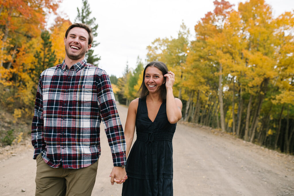 Couple celebrating their surprise engagement at Boreas Pass with  mountain views in Breckenridge, Colorado.