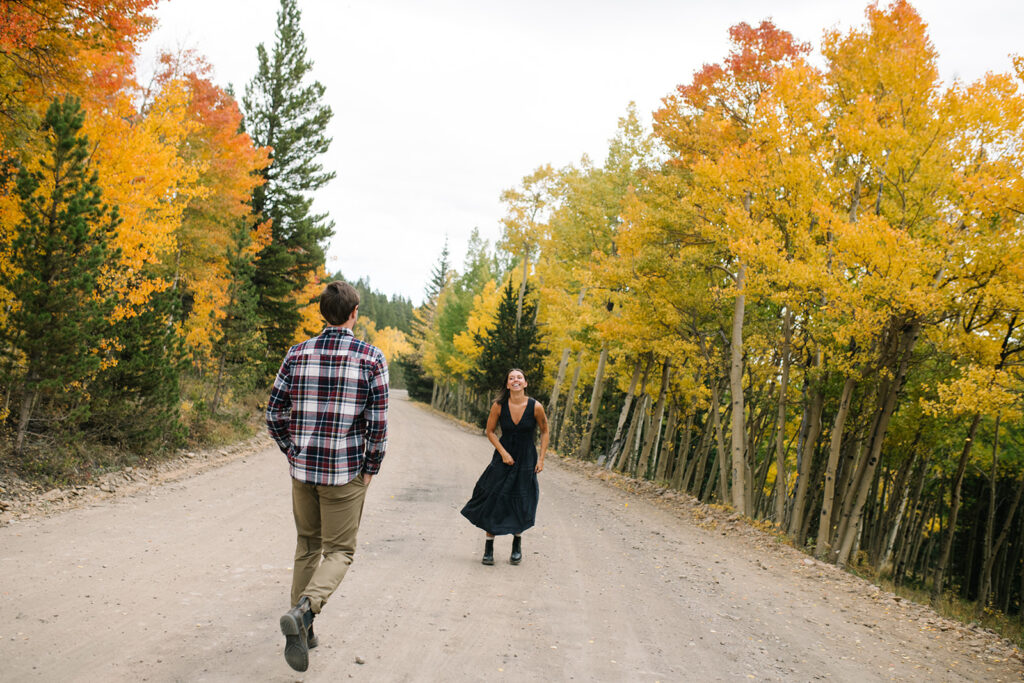 Couple celebrating their surprise engagement at Boreas Pass with  mountain views in Breckenridge, Colorado.