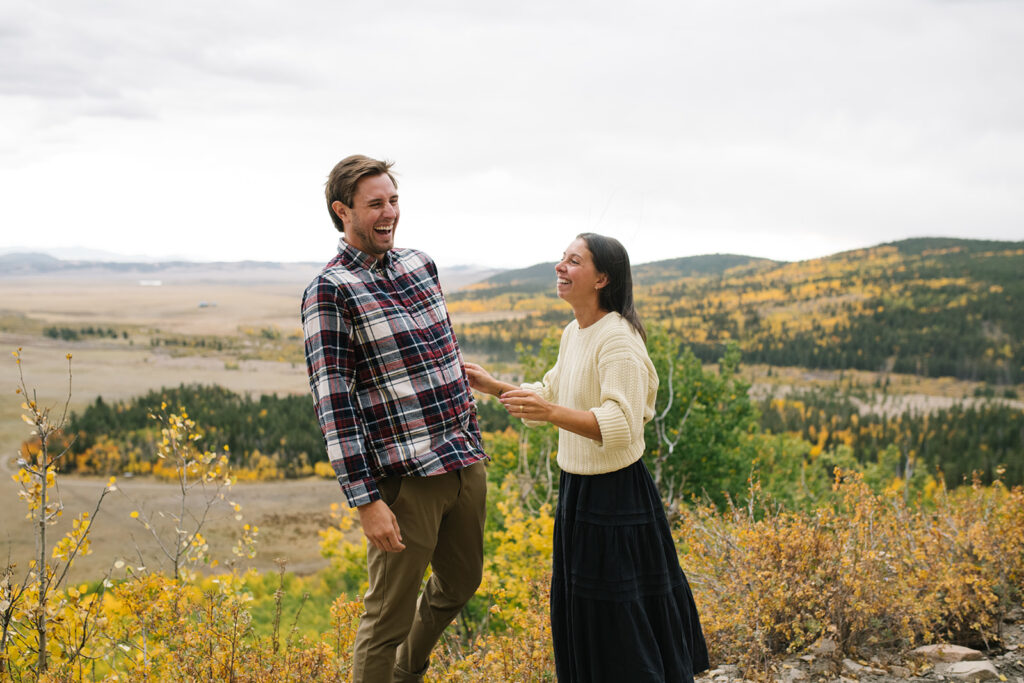 Romantic moment during a surprise proposal and engagement at Boreas Pass overlooking Breckenridg, Colorado.