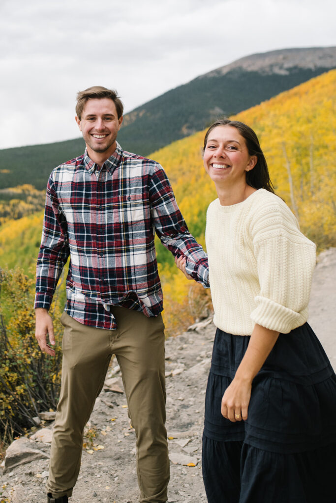 Romantic moment during a surprise proposal and engagement at Boreas Pass overlooking Breckenridg, Colorado.