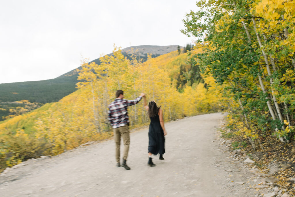 Romantic moment during a surprise proposal and engagement at Boreas Pass overlooking Breckenridg, Colorado.