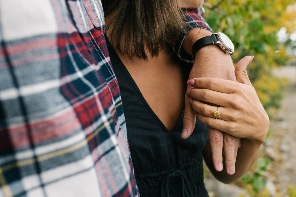 Romantic moment during a surprise proposal and engagement at Boreas Pass overlooking Breckenridg, Colorado.