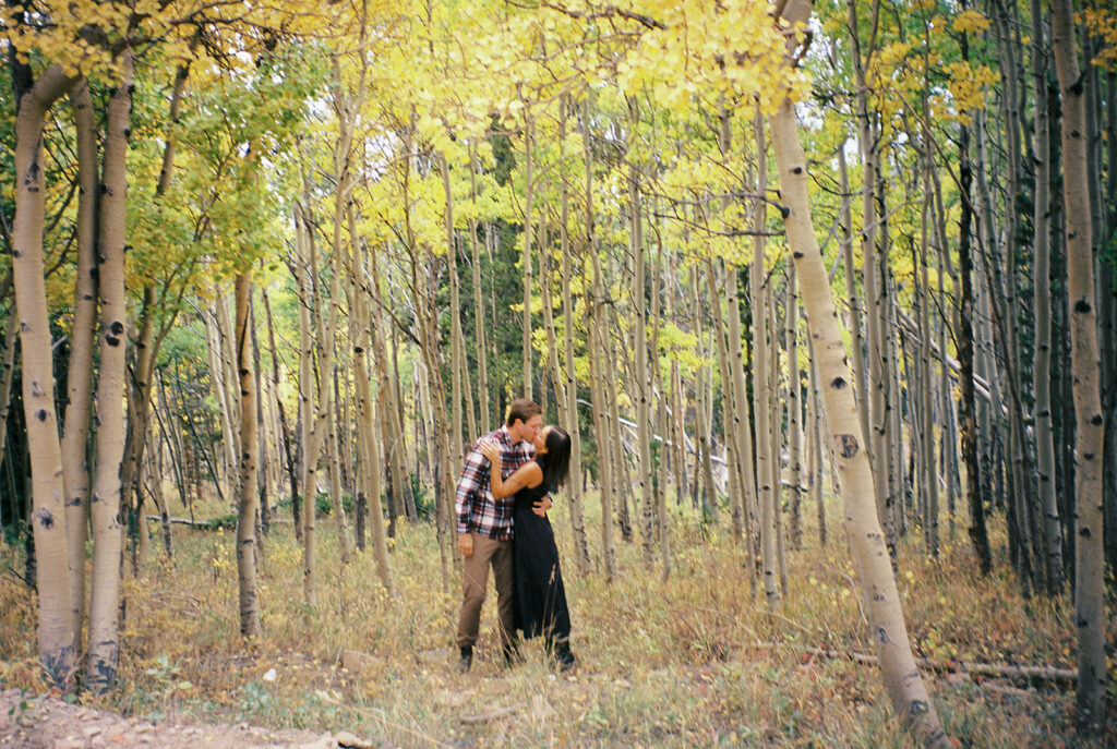 Couple celebrating their surprise engagement at Boreas Pass with  mountain views in Breckenridge, Colorado.