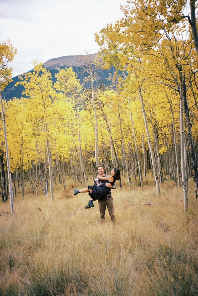 Romantic moment during a surprise proposal and engagement at Boreas Pass overlooking Breckenridg, Colorado.