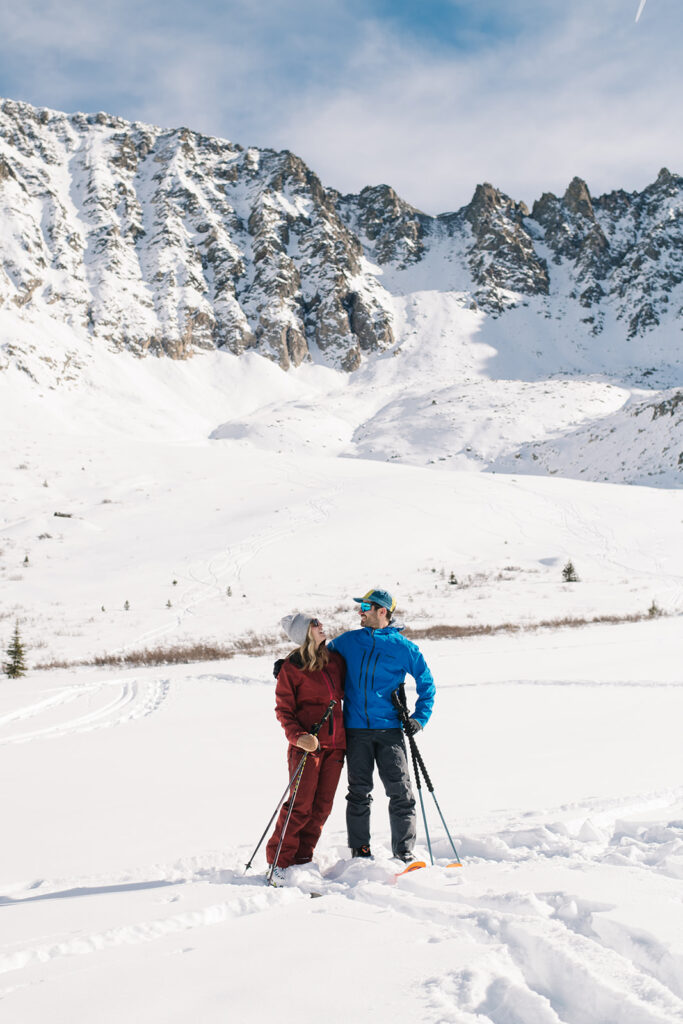 Colorado winter engagement session with a couple in the snow in skis. 