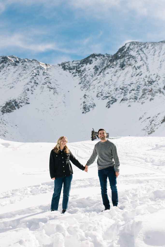 Colorado winter engagement session with a couple in the snow in skis. 