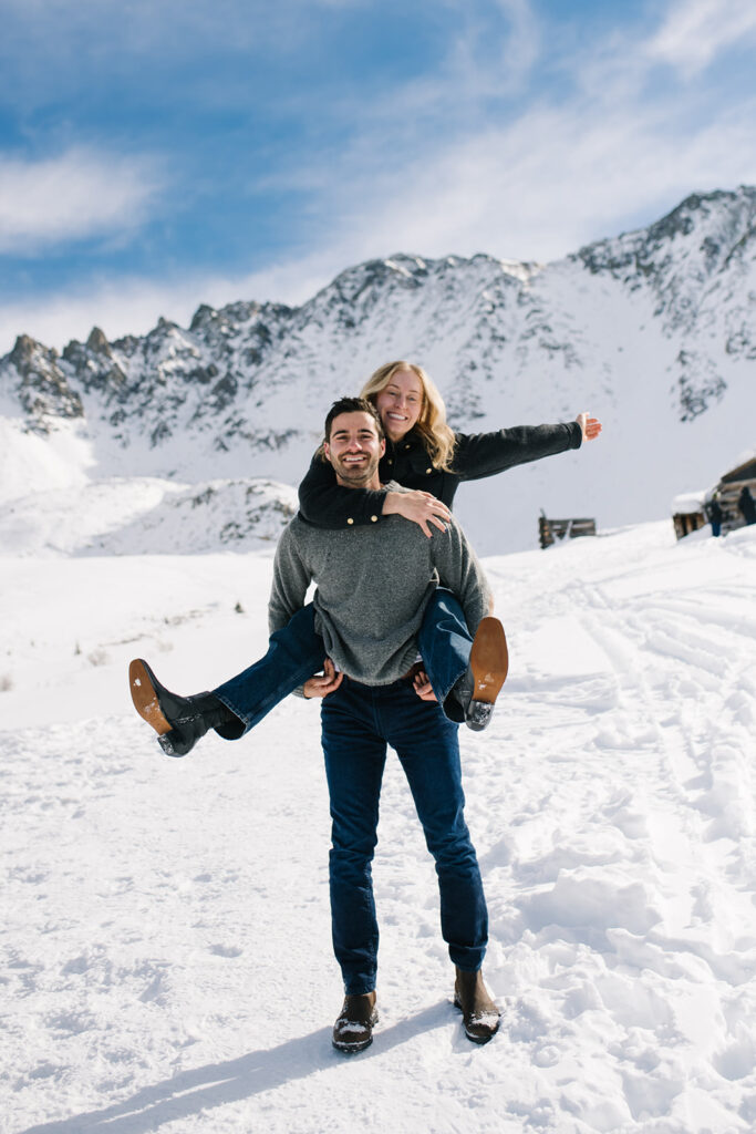 Colorado winter engagement session with a couple in the snow in skis. 
