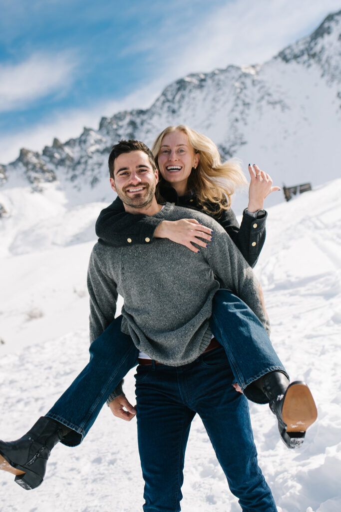 Colorado winter engagement session with a couple in the snow in skis. 