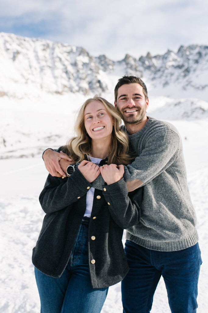 Colorado winter engagement session with a couple in the snow in skis. 