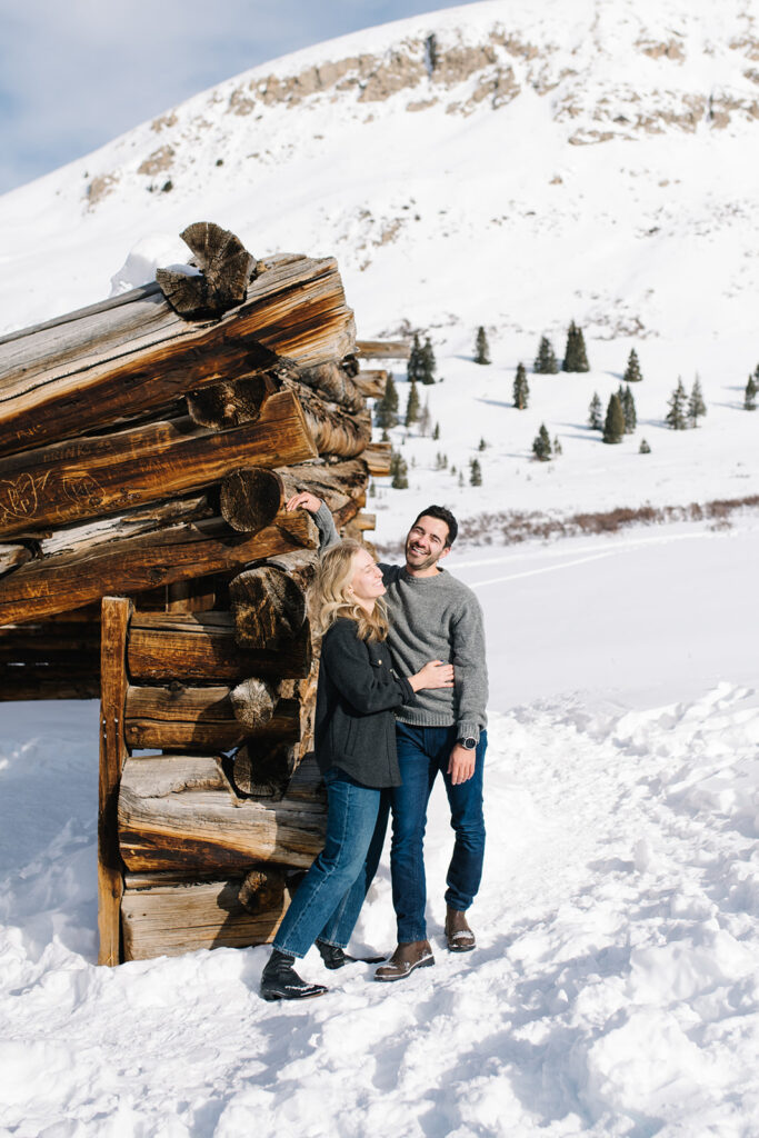 Winter engagement photos in Colorado with snow-covered mountains in the background.