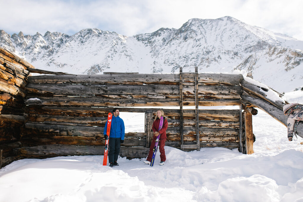 Winter engagement photos in Colorado with snow-covered mountains in the background.