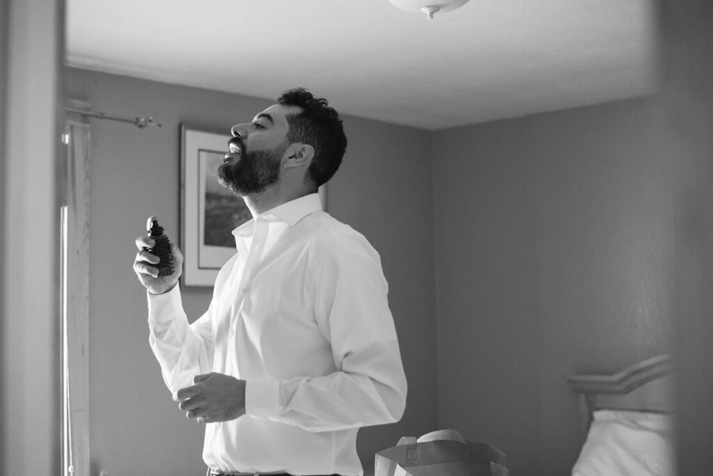 Groom buttoning his suit jacket before his wedding at Wedgewood Mountain View Ranch.