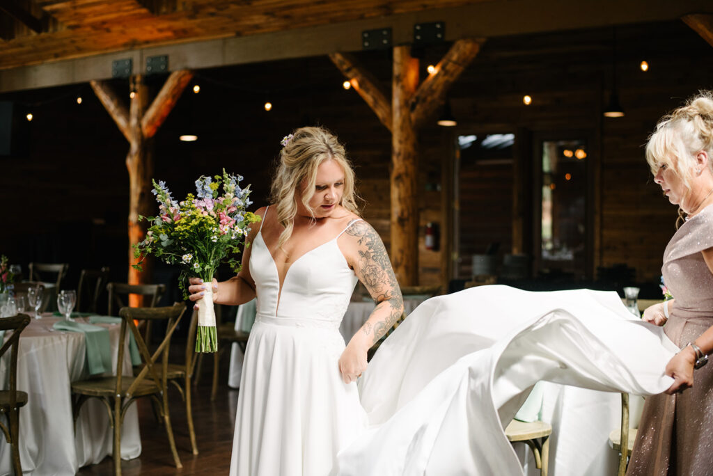 Mother of the bride fastening the wedding dress at Wedgewood Mountain View Ranch in Pine, CO.