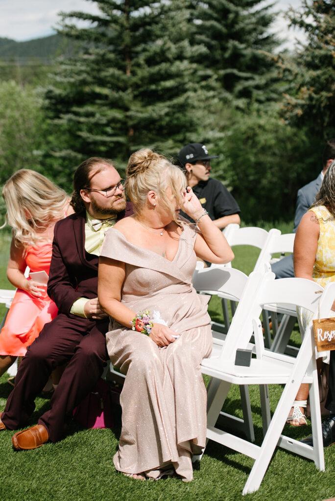 Inimate moments during the outdoor ceremony at Wedgewood Mountain View Ranch in Pine, CO with mountain views.