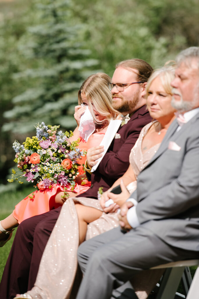 Inimate moments during the outdoor ceremony at Wedgewood Mountain View Ranch in Pine, CO with mountain views.