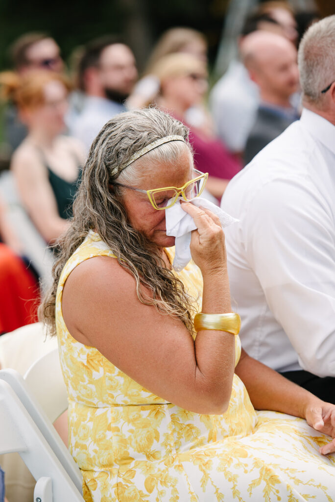 Inimate moments during the outdoor ceremony at Wedgewood Mountain View Ranch in Pine, CO with mountain views.