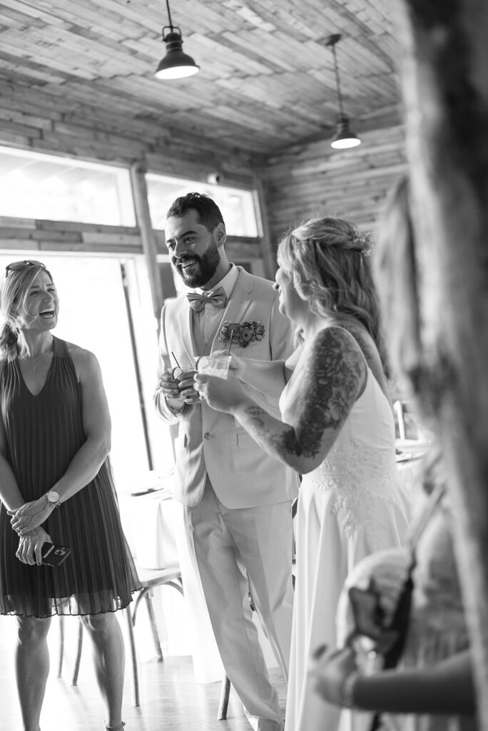 Wedding guests enjoying cocktail hour at Wedgewood Mountain View Ranch in Pine, CO, with mountain views in the background.