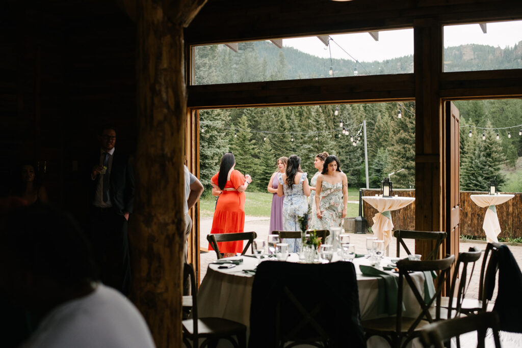 Bride and groom's during speeches  inside Wedgewood Mountain View Ranch’s lodge-style reception space.