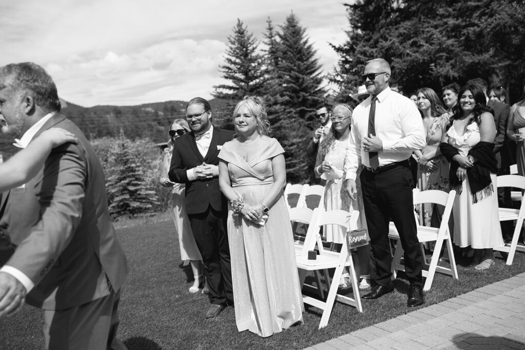 Inimate moments during the outdoor ceremony at Wedgewood Mountain View Ranch in Pine, CO with mountain views.