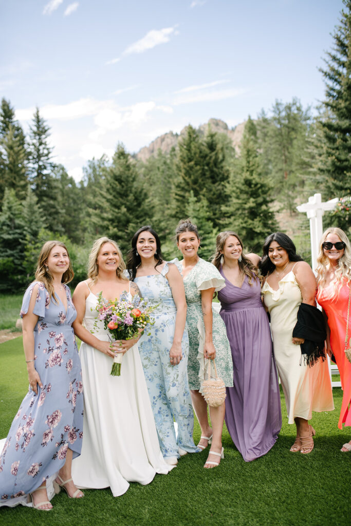 Guests relaxing outside during cocktail hour at Wedgewood Mountain View Ranch, surrounded by Colorado pine trees.