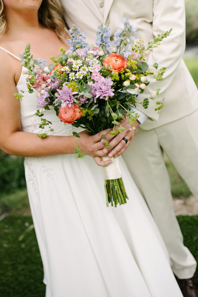 Couple at sunset at Wedgewood Mountain View Ranch wedding, with Colorado mountains in the background.