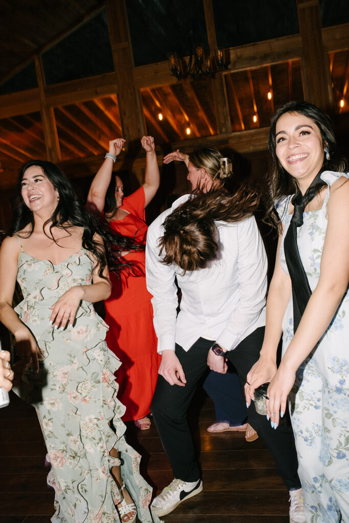 Late night dancing inside Wedgewood Mountain View Ranch’s lodge-style reception space.