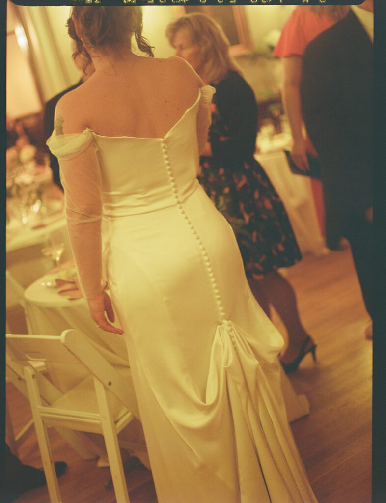 Candlelit wedding reception inside Grant Humphreys Mansion with long dinner tables
