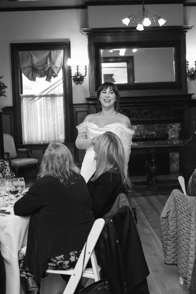 Candlelit wedding reception inside Grant Humphreys Mansion with long dinner tables

