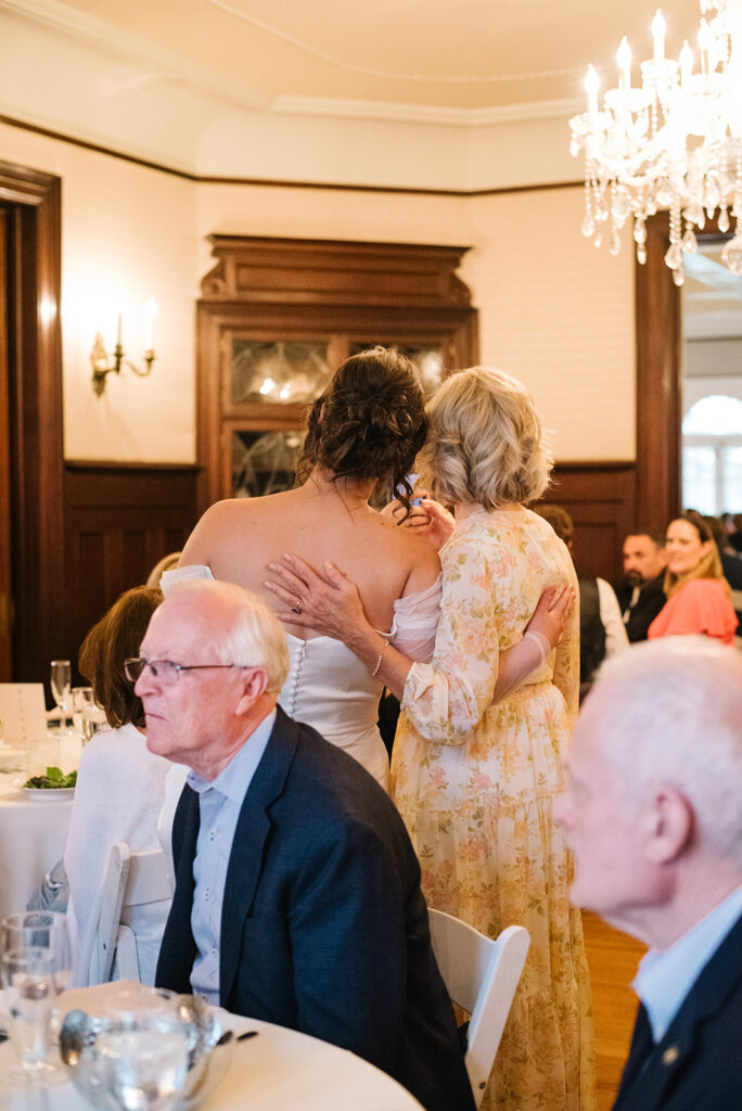 Candlelit wedding reception inside Grant Humphreys Mansion with long dinner tables
