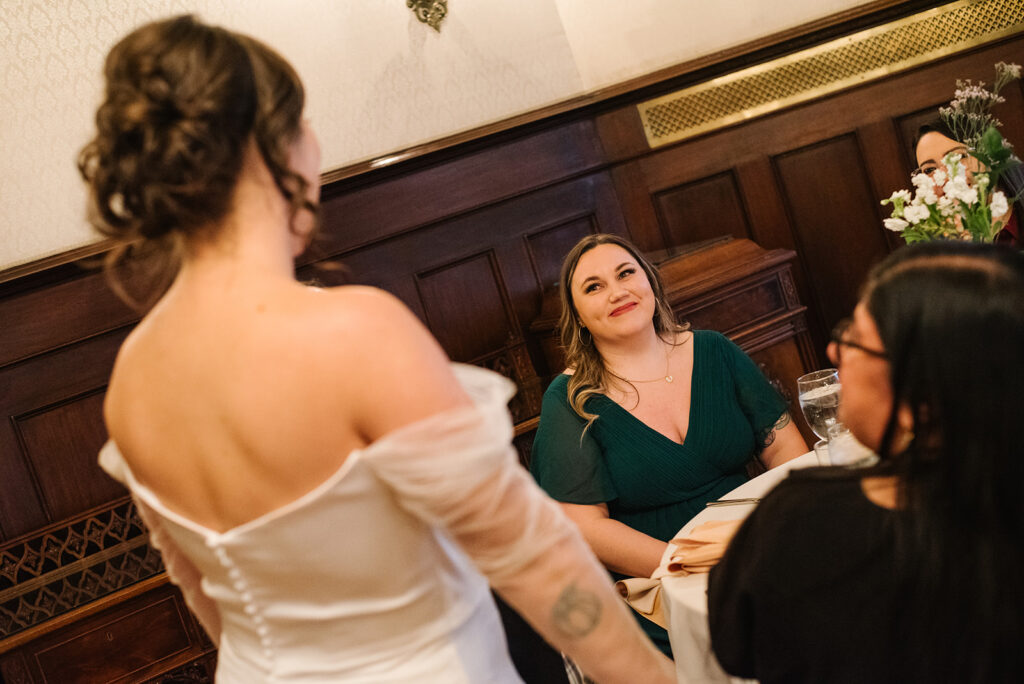 Candlelit wedding reception inside Grant Humphreys Mansion with long dinner tables
