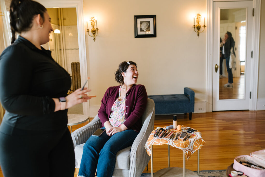 Candid photo of bride getting ready in vintage bridal suite at Grant Humphreys Mansion