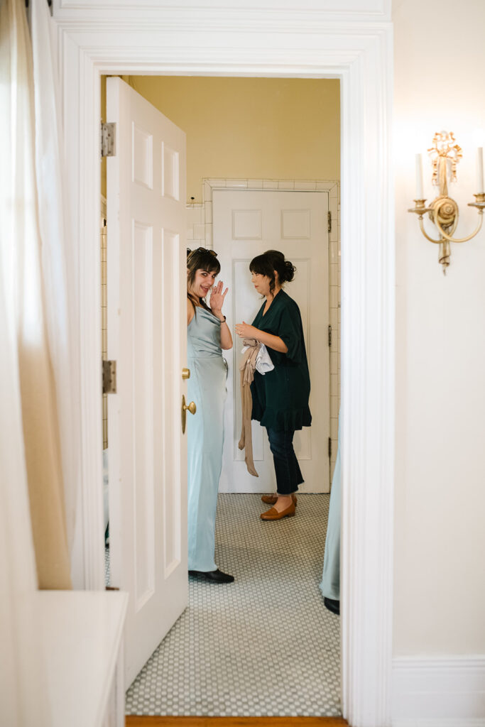 Candid photo of bride getting ready in vintage bridal suite at Grant Humphreys Mansion, denver wedding venue