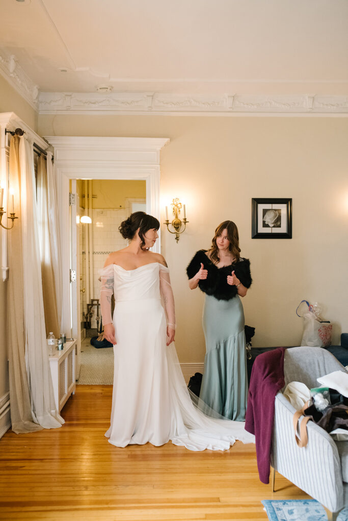 
Candid photo of bride getting ready in vintage bridal suite at Grant Humphreys Mansion, denver wedding venue