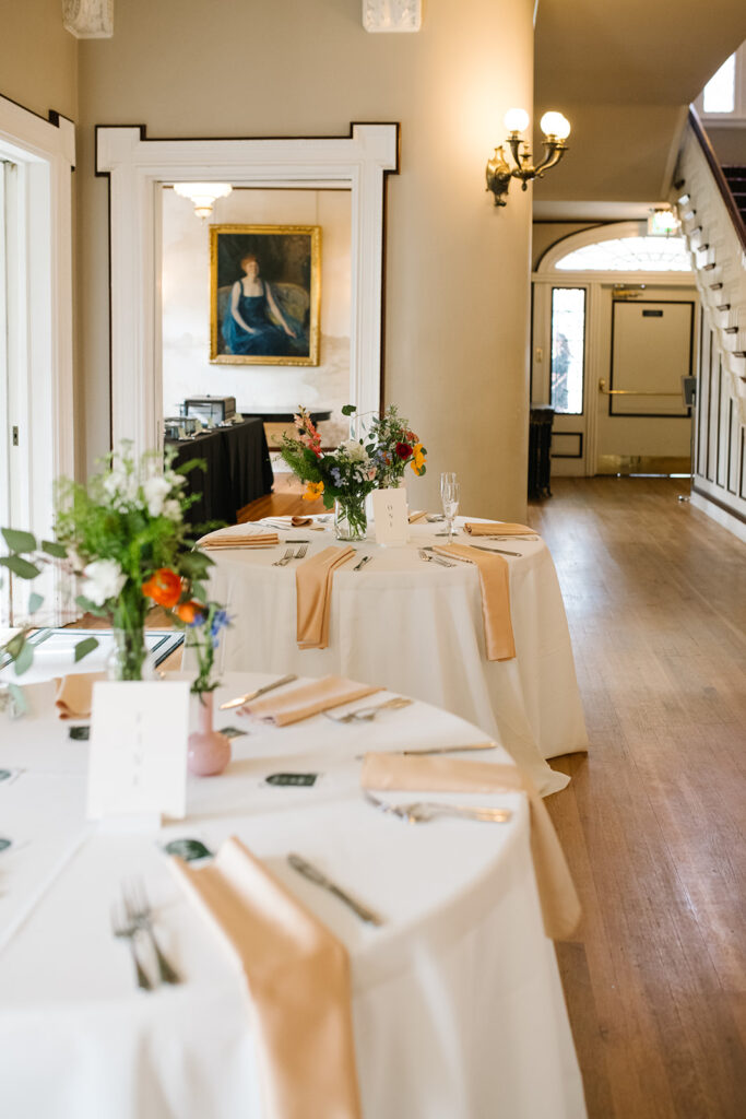 Intimate wedding dinner setup with historic wallpaper at Grant Humphreys Mansion venue
