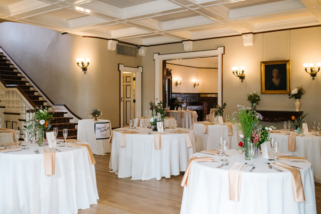Intimate wedding dinner setup with historic wallpaper at Grant Humphreys Mansion venue
