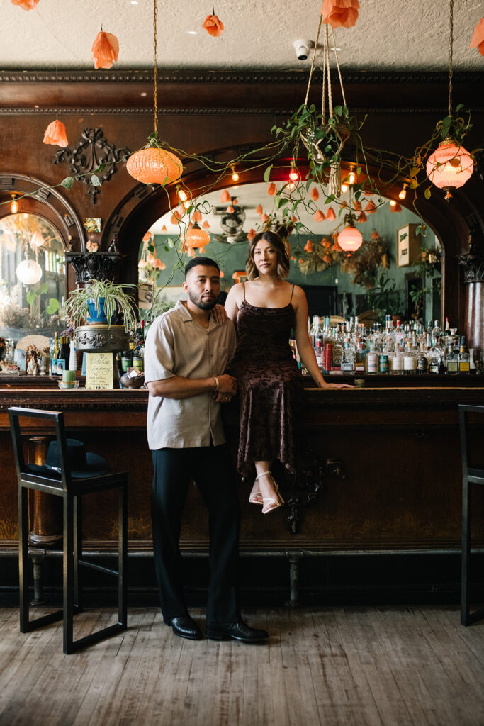 Denver engagement photo inside Fort Greene Bar’s moody interior